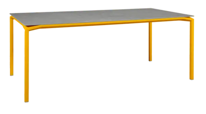 Load image into Gallery viewer, Fermob CALVI Kreta mineral dining table, 195x95cm, eight-seater with honey-colored stone tabletop and sturdy metal legs.
