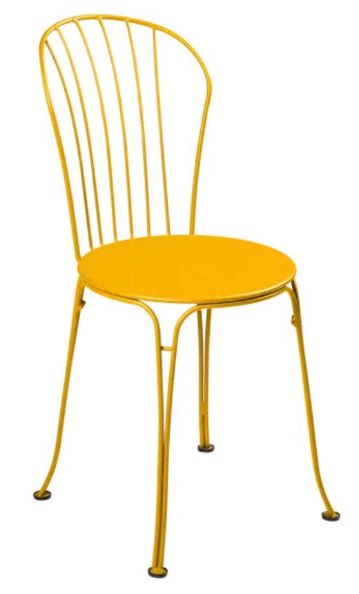 Fermob OPÉRA+ outdoor metal chair in honey color with curved backrest, suitable for patio or restaurant seating.