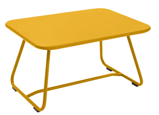 Honey-colored Fermob Sixties low outdoor table, 76x55.5cm, with a sleek, minimalist design suitable for patio or garden use.