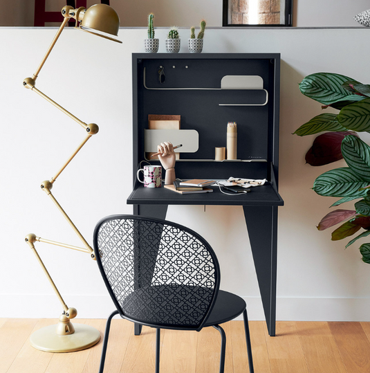 Wall-mounted Fermob Face à Face writing desk with a honey-colored wooden surface and sleek modern design.