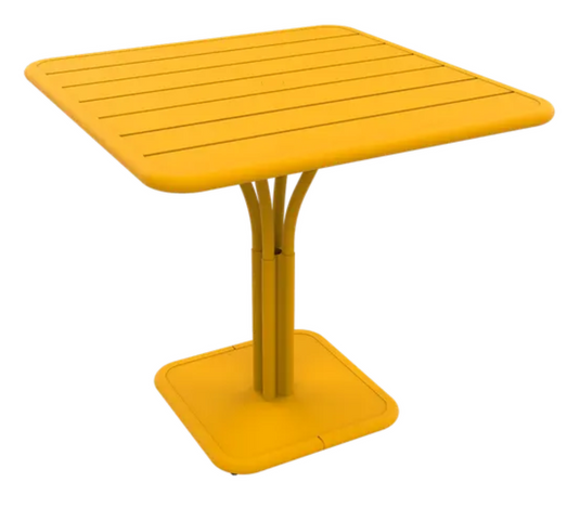 Honey white Fermob Luxembourg outdoor pedestal table, 80x80 cm, with a sleek round design and sturdy pedestal base.