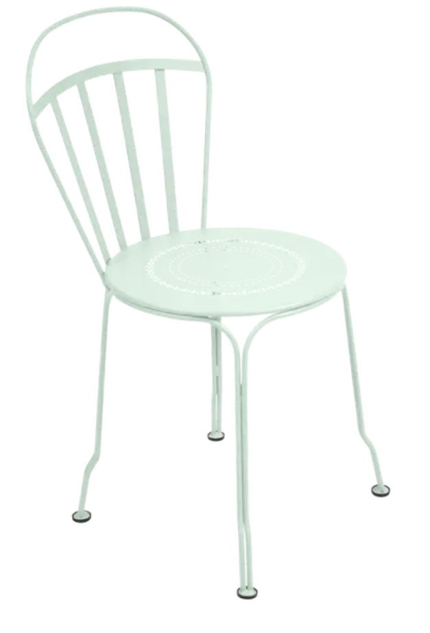 Load image into Gallery viewer, Ice Mint Fermob Louvre outdoor chair with a curved metal frame and slatted seat, designed for stylish outdoor seating.
