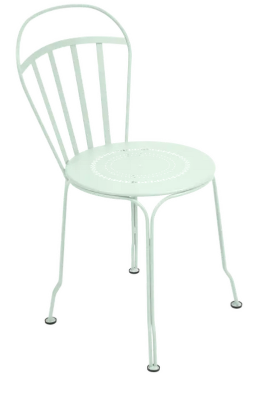 Ice Mint Fermob Louvre outdoor chair with a curved metal frame and slatted seat, designed for stylish outdoor seating.