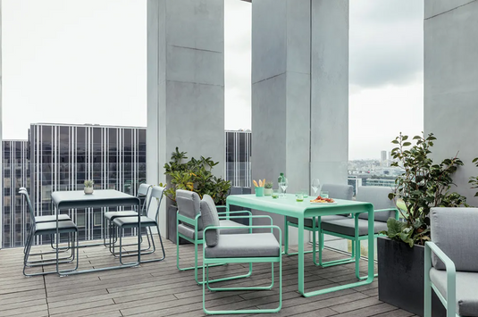 Fermob Bellevie Chair V2, a sleek outdoor metal chair with curved armrests and modern design, ideal for garden or patio.