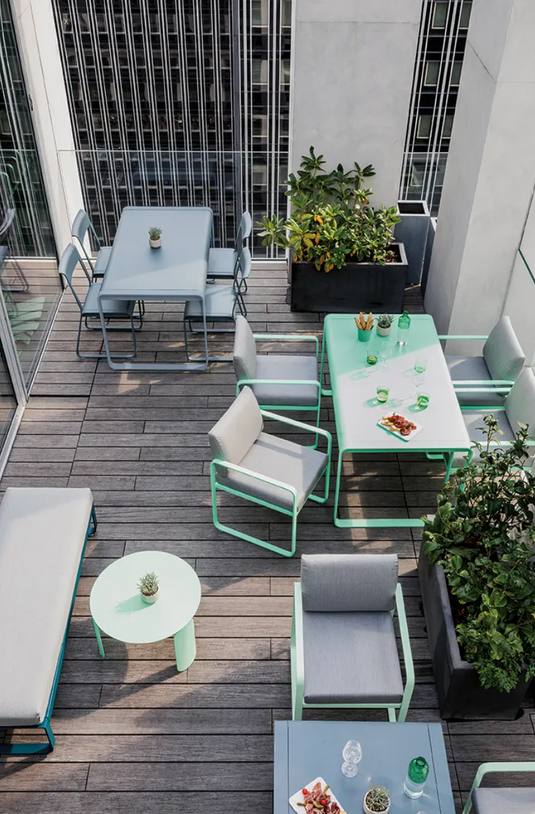 Fermob Bellevie Chair V2, metal outdoor chair with a sleek design, shown in a natural setting.