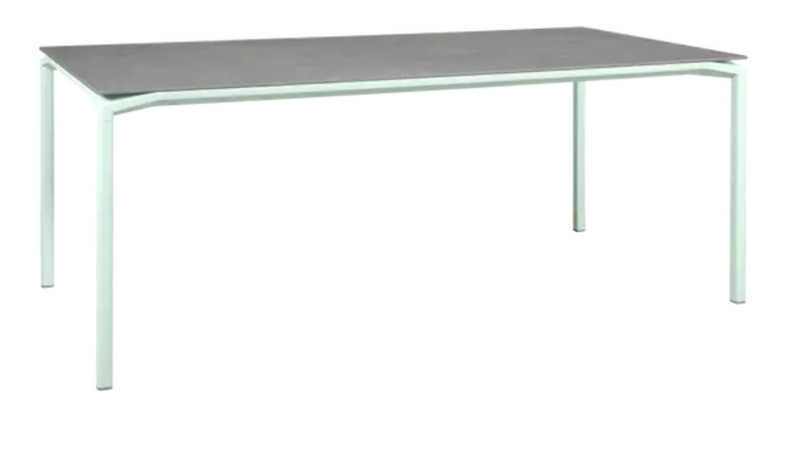 Load image into Gallery viewer, Fermob CALVI Kreta mineral dining table, 195x95cm, eight-seater with a mint-colored concrete tabletop and sturdy metal legs.
