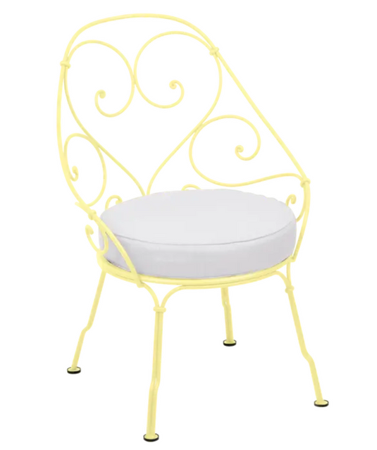 Lemon Off-White Fermob Cabriolet outdoor armchair with metal frame and armrests, stylish patio furniture for outdoor seating.