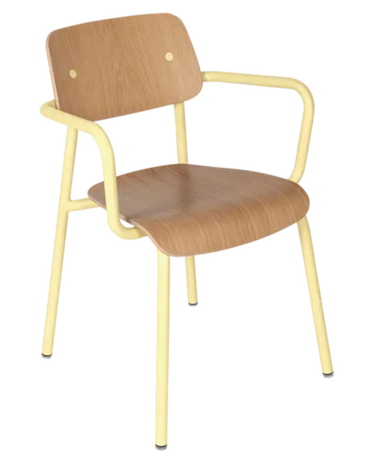 Fermob Studie Oak outdoor armchair with wooden armrests, shown in a modern office or meeting room setting.