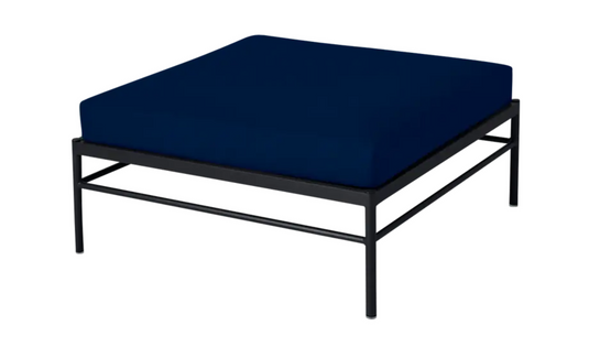 Midnight blue Fermob Rivage outdoor ottoman with aluminum frame, versatile lounge footstool for patio or garden seating.