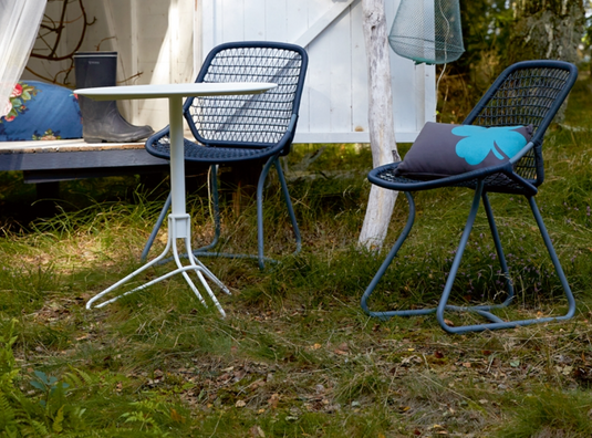 Stackable Fermob Sixties outdoor chair in liquorice color, designed for restaurant and hospitality use in Ireland.
