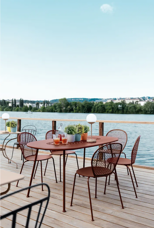 Fermob Lorette oval metal outdoor dining table, 160 x 90 cm, showing a sleek, modern design ideal for outdoor dining spaces.