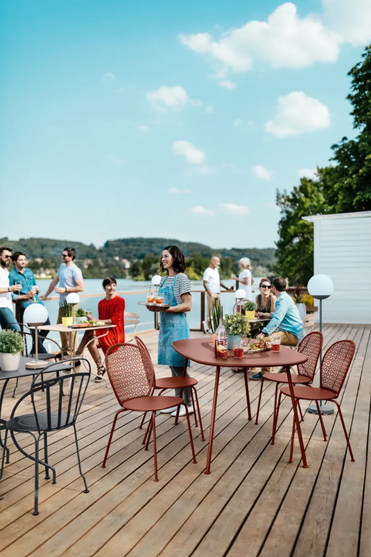 Fermob Lorette oval metal outdoor dining table, 160 x 90 cm, featuring a sleek design and sturdy metal construction for outdoor use.