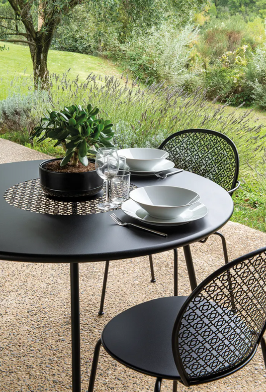Fermob Lorette round garden table with 110 cm diameter in fire-resistant metal, stylish outdoor furniture piece.