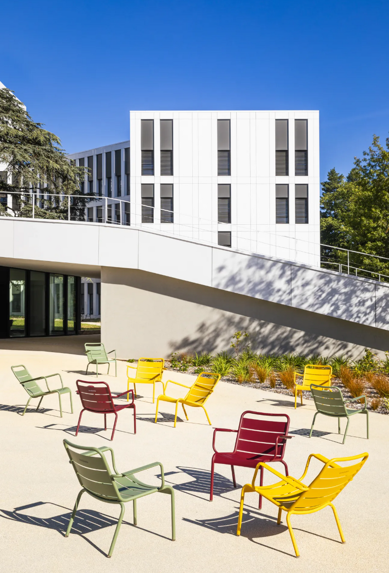 Load image into Gallery viewer, Fermob Luxembourg garden armchair lounge with a woven seat and armrests, designed for outdoor patio or garden seating.

