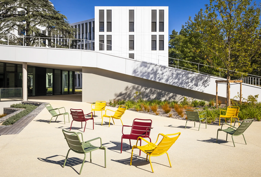 Fermob Luxembourg garden armchair lounge with metal frame and woven seat, ideal for outdoor patio or garden relaxation.
