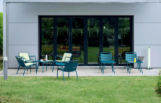 Fermob Luxembourg lounge garden armchair with curved metal frame and comfortable outdoor seating in a stylish design.