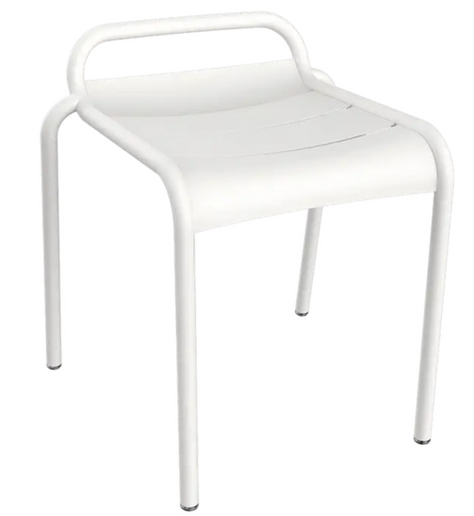 Fermob Luxembourg outdoor stool shown in a garden setting, featuring a stylish metal design perfect for outdoor dining and seating.