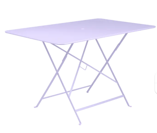 Marshmallow blue Fermob foldable bistro table, 117 x 77 cm, outdoor metal furniture, shown in a stylish outdoor setting