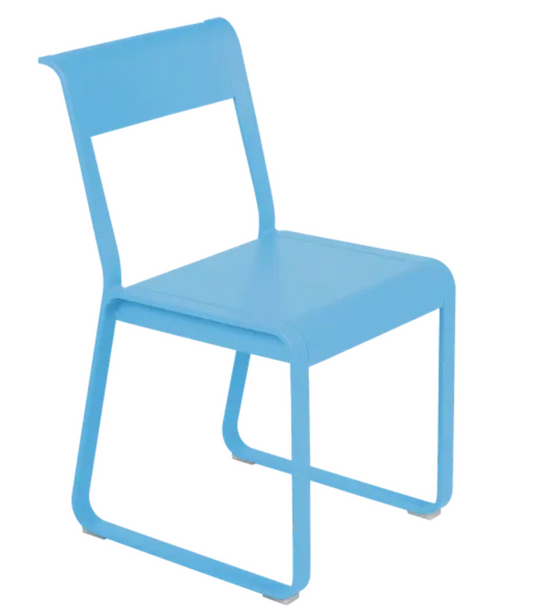Blue Fermob Bellevie Chair V2, a stylish metal outdoor chair with a modern design, shown in a natural outdoor setting.