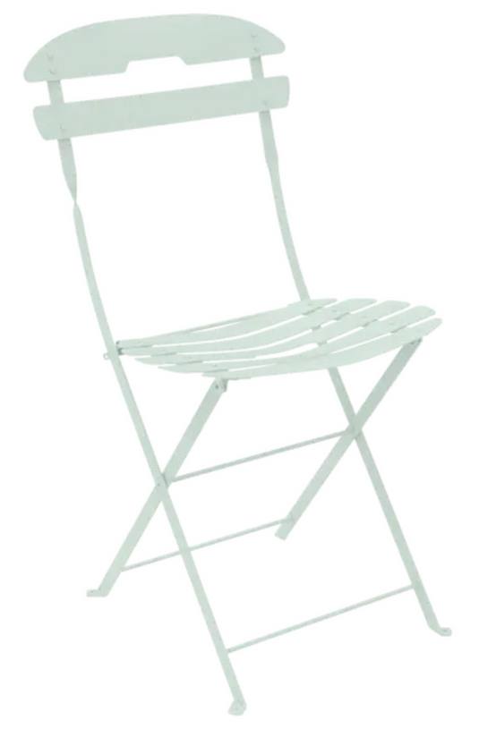 Mint green Fermob LA MÔME folding chair with a sleek, modern design, perfect for outdoor patio or garden seating.