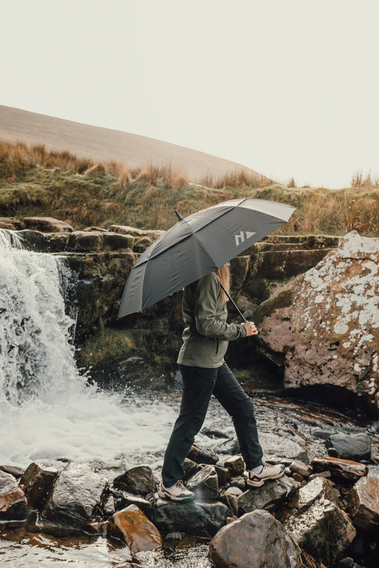 Nordic Drift 27-inch AWARE RPET storm umbrella with UPF 50+ sun protection, featuring a durable, eco-friendly design and sturdy handle.