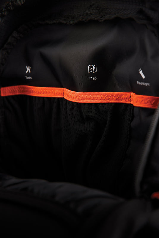 Nordic Drift Trail RCS 33L backpack, black with multiple compartments, designed for travel and outdoor adventures.