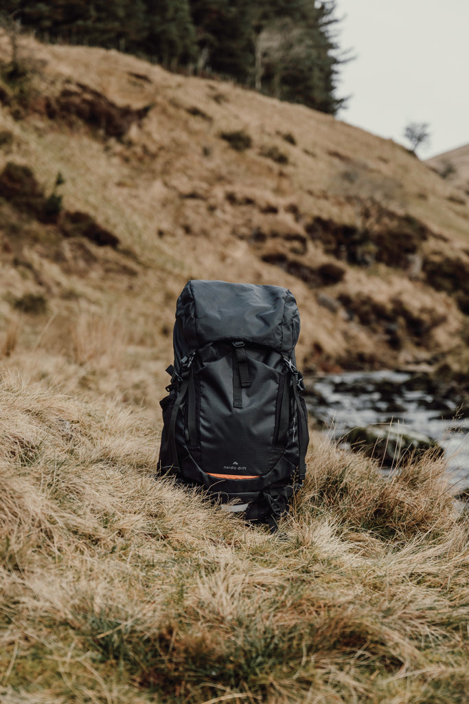Load image into Gallery viewer, Nordic Drift Trail RCS 33L backpack in black with multiple compartments, designed for travel and outdoor adventures.
