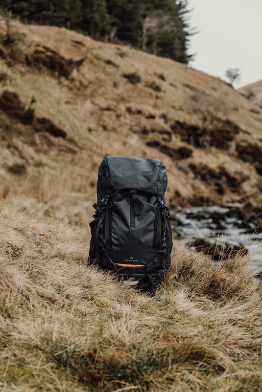 Nordic Drift Trail RCS 33L backpack in black with multiple compartments, designed for travel and outdoor adventures.
