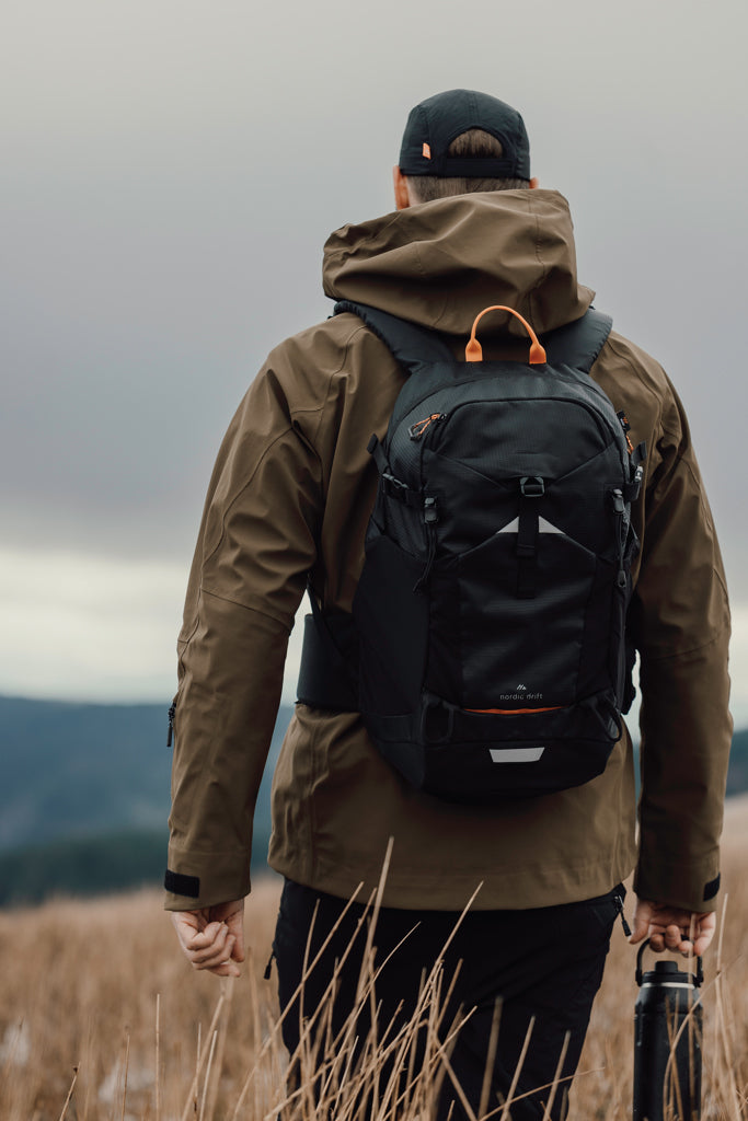 Load image into Gallery viewer, Nordic Drift Trail RCS backpack 24L in black, featuring adjustable straps and multiple compartments for travel and everyday use.
