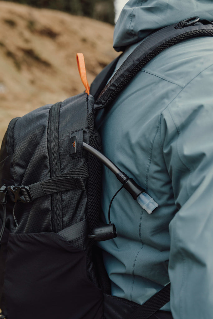 Load image into Gallery viewer, Nordic Drift Trail RCS 24L backpack with multiple compartments, durable black fabric, and adjustable straps for outdoor travel and hiking.
