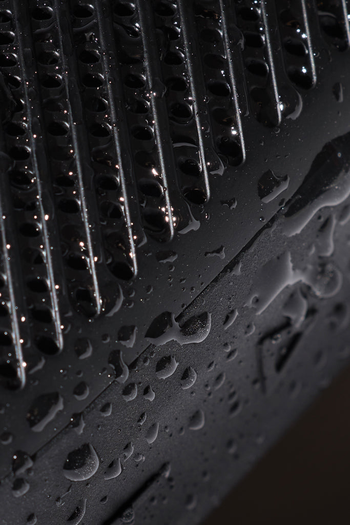 Load image into Gallery viewer, Nordic Drift Titan IP67 water and dustproof 5W portable speaker showing a rugged black design with control buttons on top.
