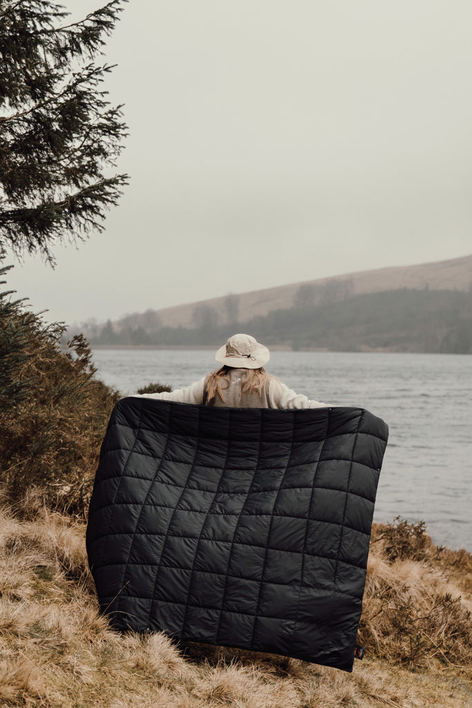 Load image into Gallery viewer, Nordic Drift GRS 3-in-1 Adventure Blanket outdoors, showing its versatile design and cozy fabric for outdoor activities and camping.

