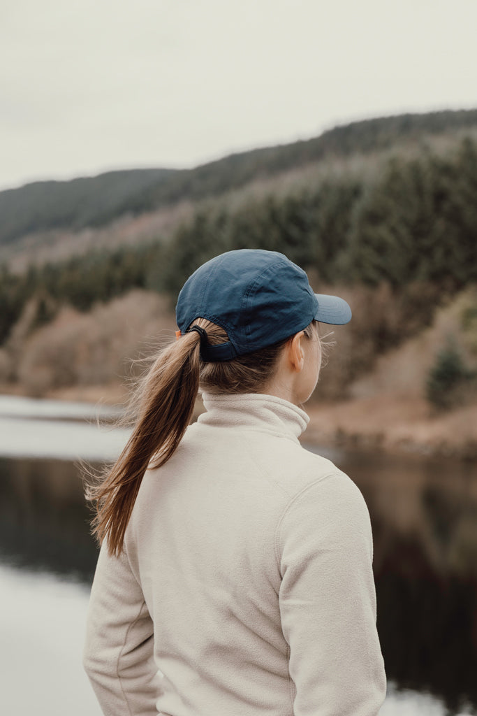 Load image into Gallery viewer, Nordic Drift RCS Aero UPF 50+ cap shown on a head, featuring a sleek design and adjustable strap for sun protection and style.
