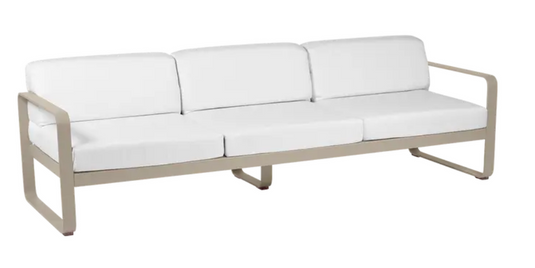 Bellevie 3-seater outdoor sofa by Fermob with a nutmeg-colored metal frame and off-white cushion, suitable for outdoor terrace.