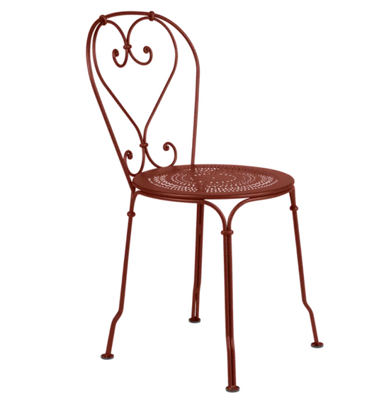 Ochre Fermob 1900 outdoor chair with a curved metal frame and slatted seat, ideal for garden or patio seating.