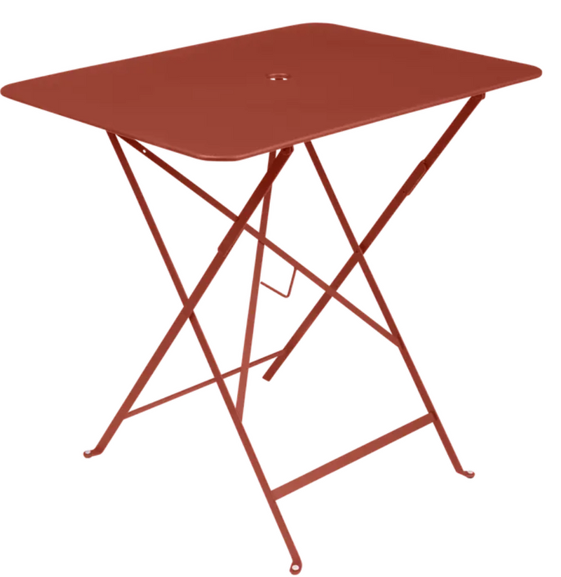 Load image into Gallery viewer, Fermob foldable bistro table in ochre, 77 x 57 cm, metal outdoor furniture, showing its compact, foldable design and sturdy surface.
