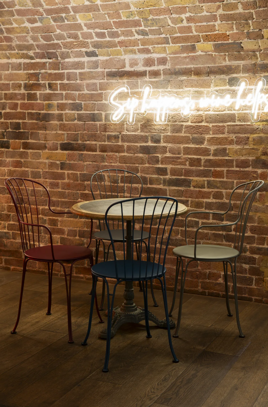 Fermob OPÉRA+ metal outdoor chair with curved backrest and armrests, suitable for restaurant and patio outdoor seating.