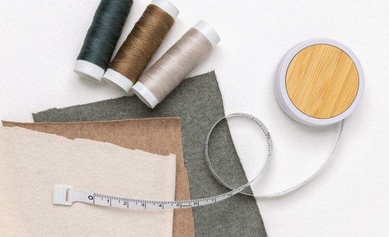 Load image into Gallery viewer, XD Collection RCS recycled plastic and bamboo tailor tape, flexible sewing tool with eco-friendly materials, shown coiled in the image.

