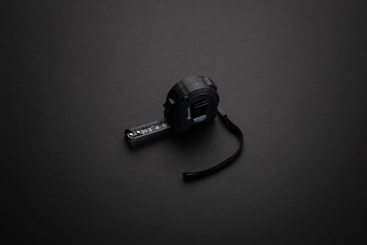 Gear X 5M measuring tape with slow/fast retract function, compact tools and torches, durable construction for precise measurements.