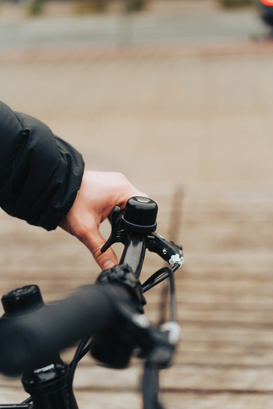 XD Collection Bike Finder Dual RCS bike bell with global locating feature on a smartphone, highlighting its phone and tablet accessory functionality.