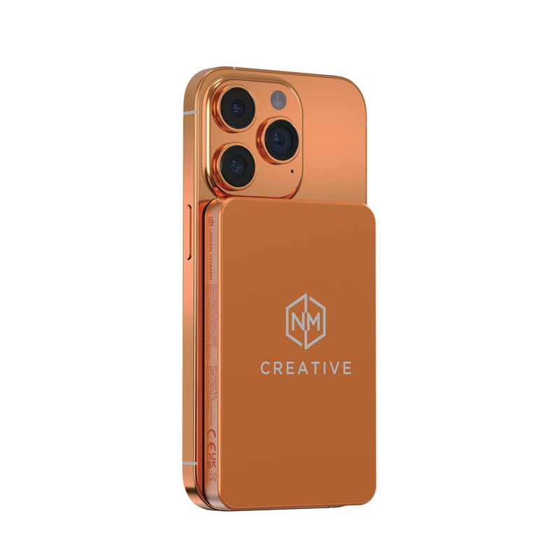 Load image into Gallery viewer, Urban Vitamin Marin 5000mAh magnetic wireless powerbank for phones and tablets, with 15W fast charging, shown attached to a device.

