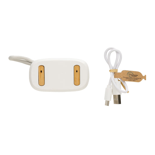 XD Collection RCS recycled plastic and bamboo TWS earbuds resting on a white surface, showcasing eco-friendly wireless audio headphones.