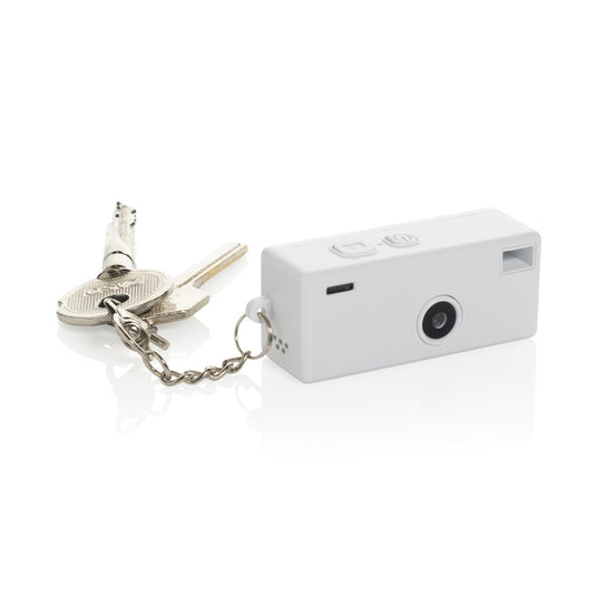 XD Xclusive Cliq it RCS recycled keychain camera attached to a phone, showing its compact design and eco-friendly materials.