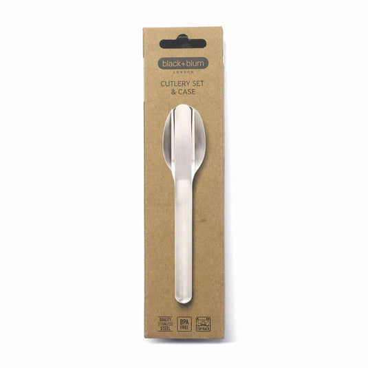Black+Blum outdoor cutlery set with stainless steel fork, knife, and spoon arranged on a wooden surface.