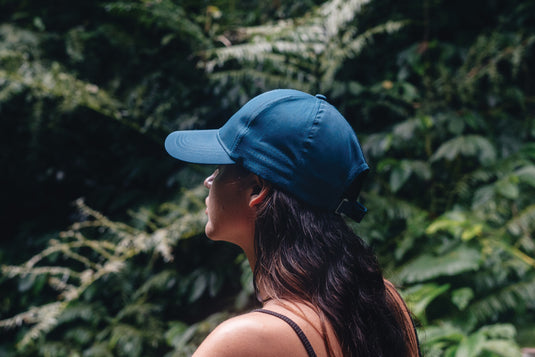 Impact AWARE™ RPET 6-panel sports cap by XD Collection, showing the green recycled polyester headwear with a curved brim.