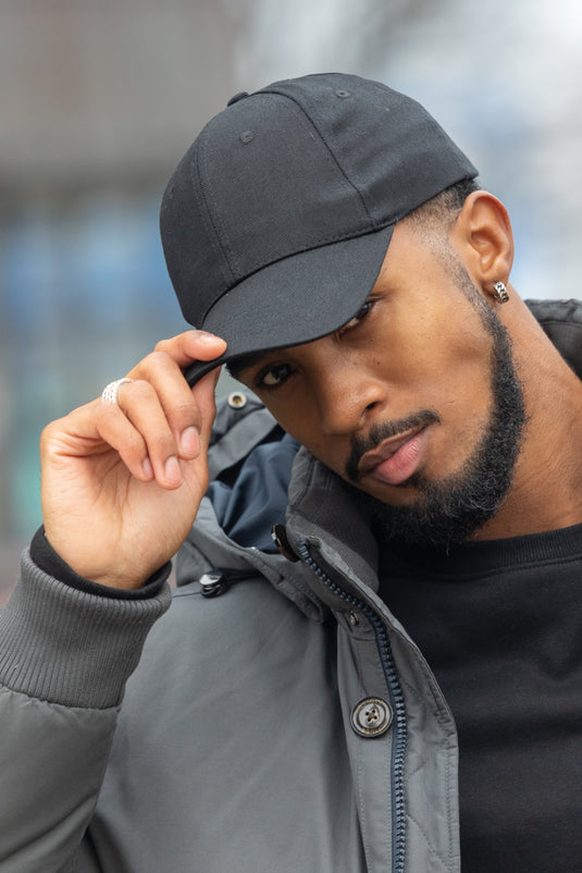 Six-panel recycled cotton cap by XD Collection with AWARE™ tracer, showcasing its eco-friendly design and classic headwear style.