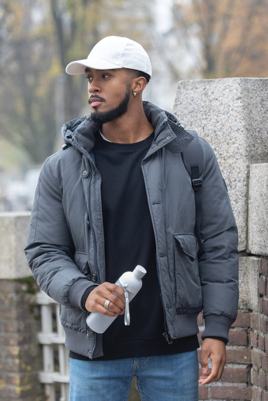 Six-panel recycled cotton cap from XD Collection with AWARE™ tracer, showcasing eco-friendly headwear design.