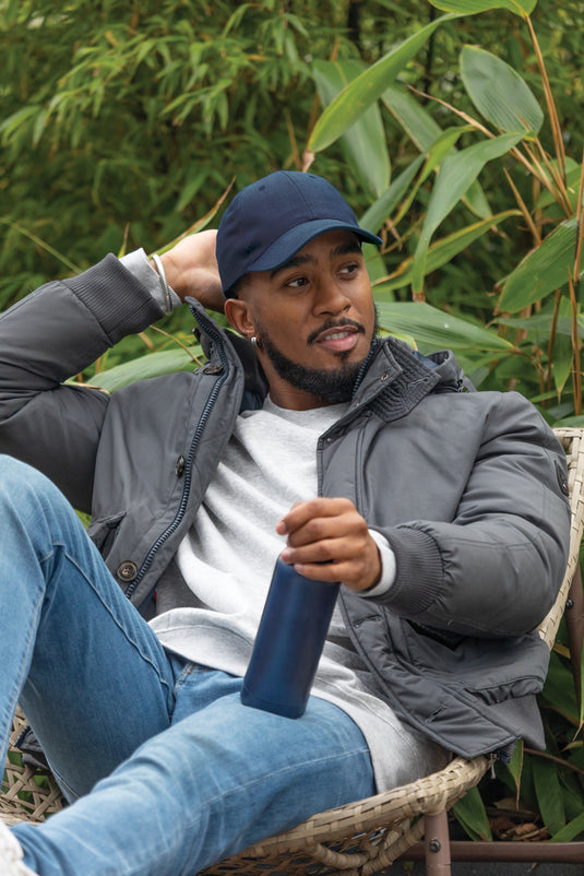 Six-panel recycled cotton cap with AWARE™ tracer by XD Collection, showcasing its eco-friendly design and casual headwear style.