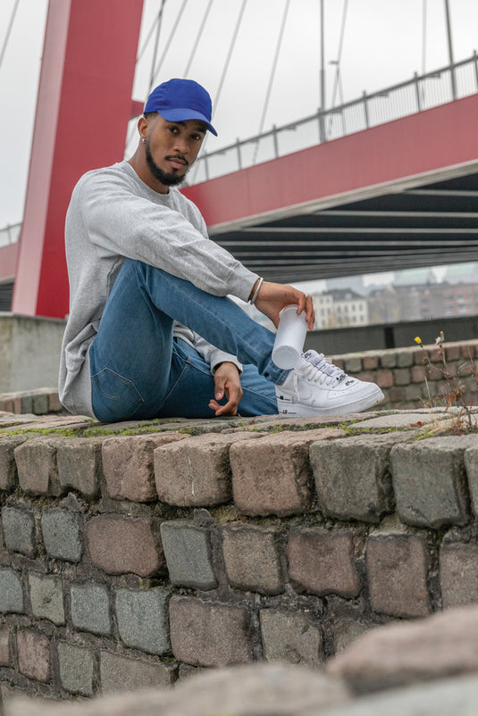 Six-panel recycled cotton cap from XD Collection with AWARE™ tracer, showcasing eco-friendly headwear in natural fabric and design.