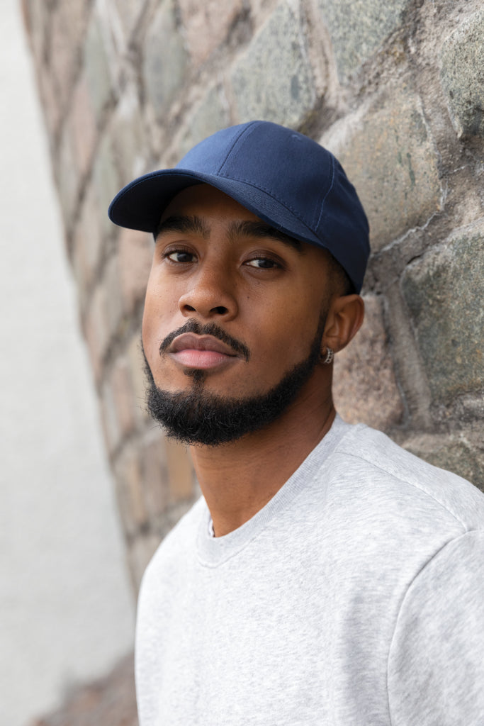 Load image into Gallery viewer, Six-panel XD Collection recycled cotton cap with AWARE™ tracer, showcasing its eco-friendly design and adjustable fit.
